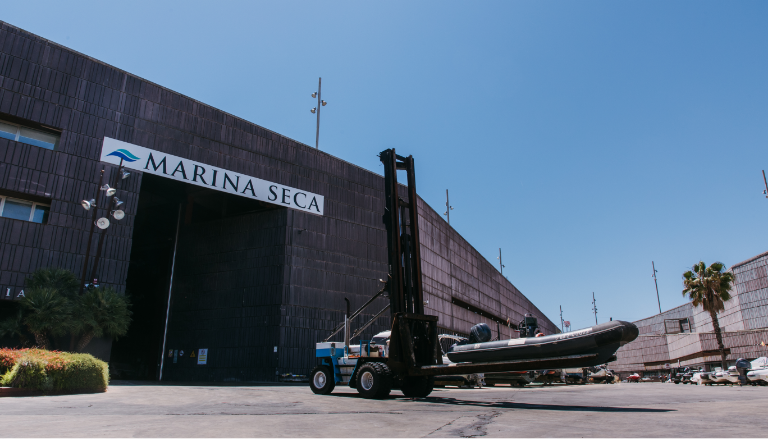 Carretilla elevadora transportando barco en Marina Seca