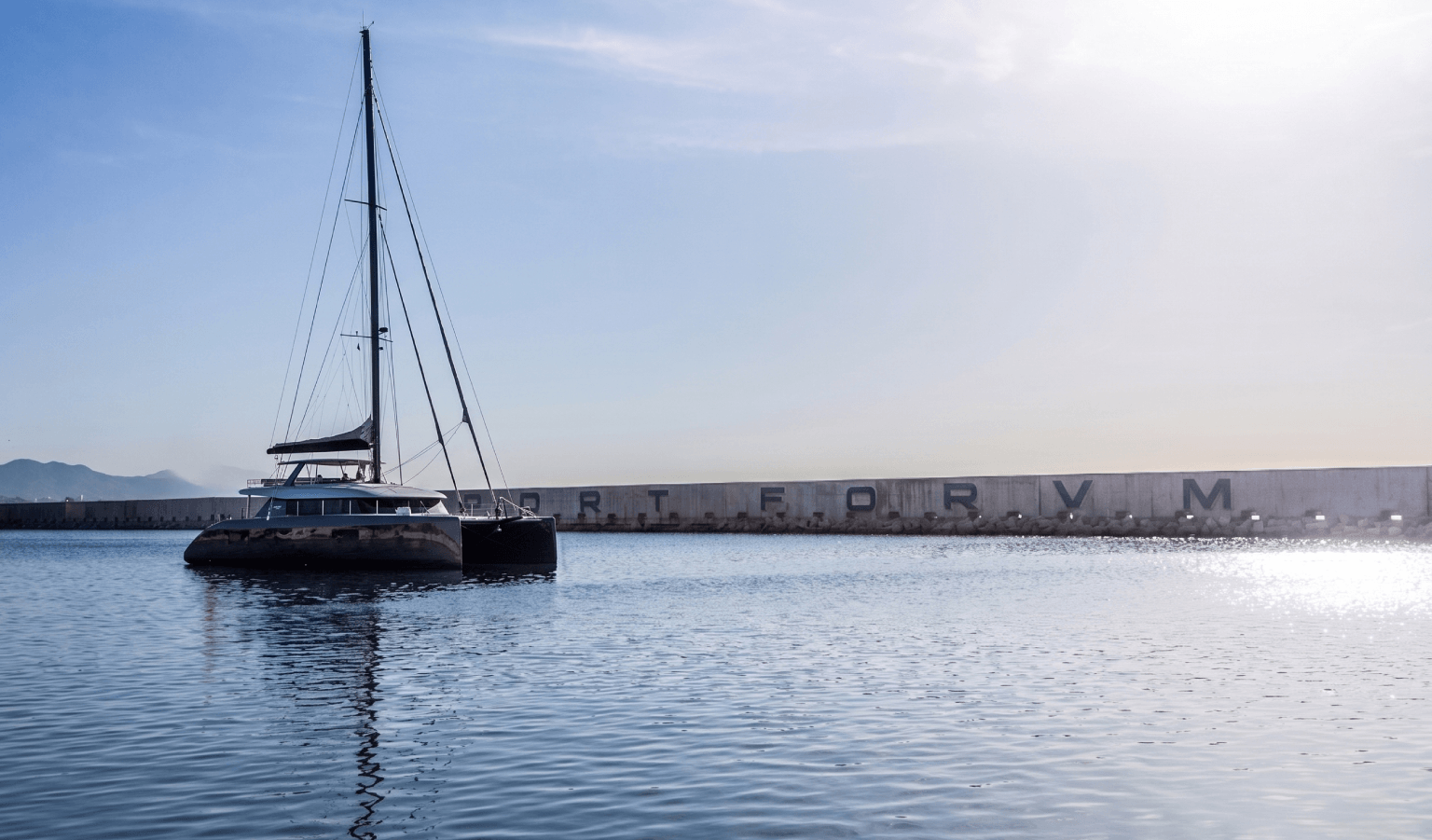 Catamarán en puerto con muro de hormigón